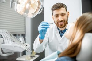 A close-up of a person gently brushing their teeth with a toothbrush in a well-lit bathroom.