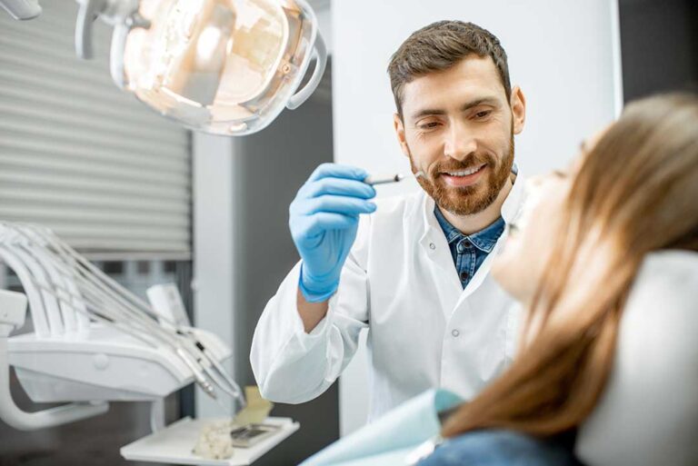 A close-up of a person gently brushing their teeth with a toothbrush in a well-lit bathroom.